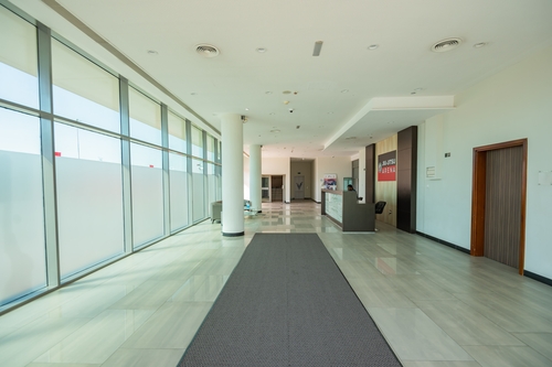 Large warehouse with cement floors and high ceiling windows